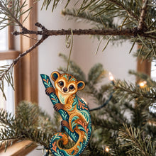 Load image into Gallery viewer, Laser-cut maple wood Kinkajou folk art ornament O409 hanging on a fir branch, made in USA
