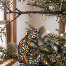 Load image into Gallery viewer, Laser-cut maple wood Binturong folk art ornament O410 hanging on a fir branch, made in USA
