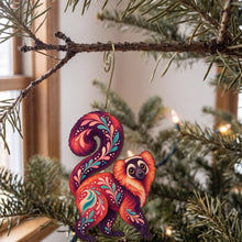 Load image into Gallery viewer, Laser-cut maple wood Red Ruffed Lemur folk art ornament O412 hanging on a fir branch, made in USA
